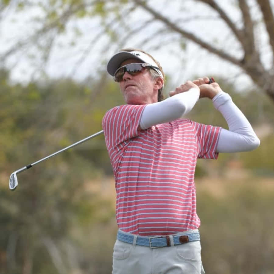 Brett Quigley In Mid-swing During A Golf Tournament Wallpaper