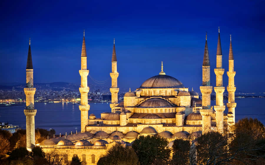 Bright Blue Mosque In Night Sky Wallpaper