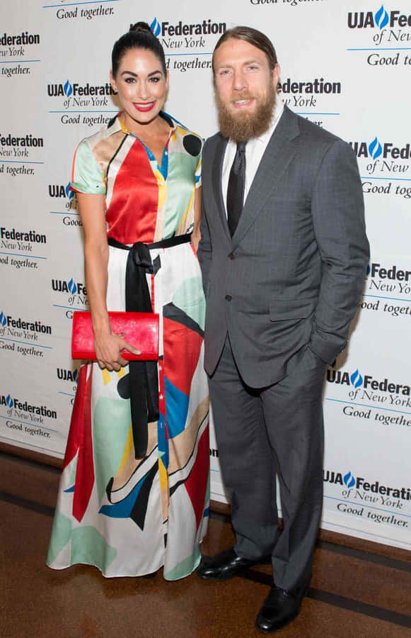 Bryan Danielson And Brie Bella Celebrating Their Love Wallpaper