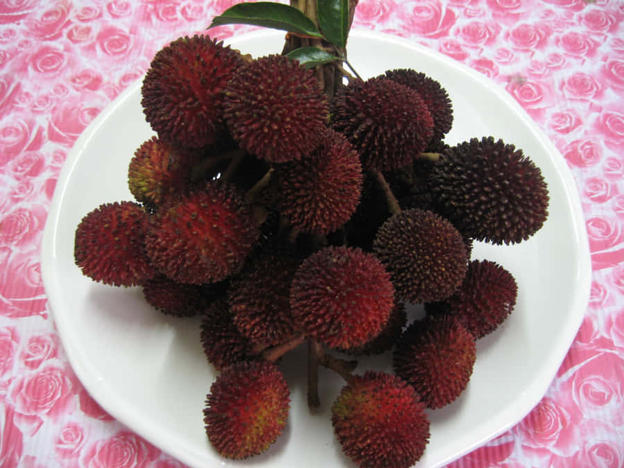 Bunch Of Pulasan Fruits On Plate Wallpaper