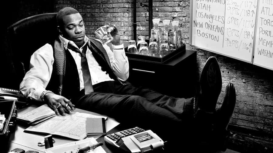 Businessman Relaxingin Office Blackand White Wallpaper