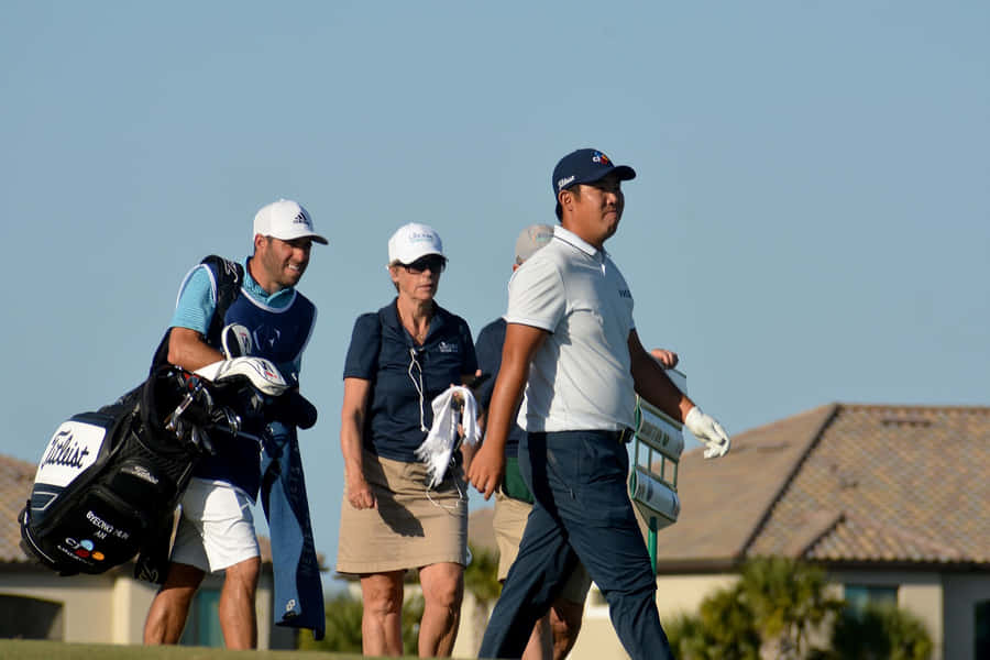 Byeong Hun An And His Caddie Walking Wallpaper