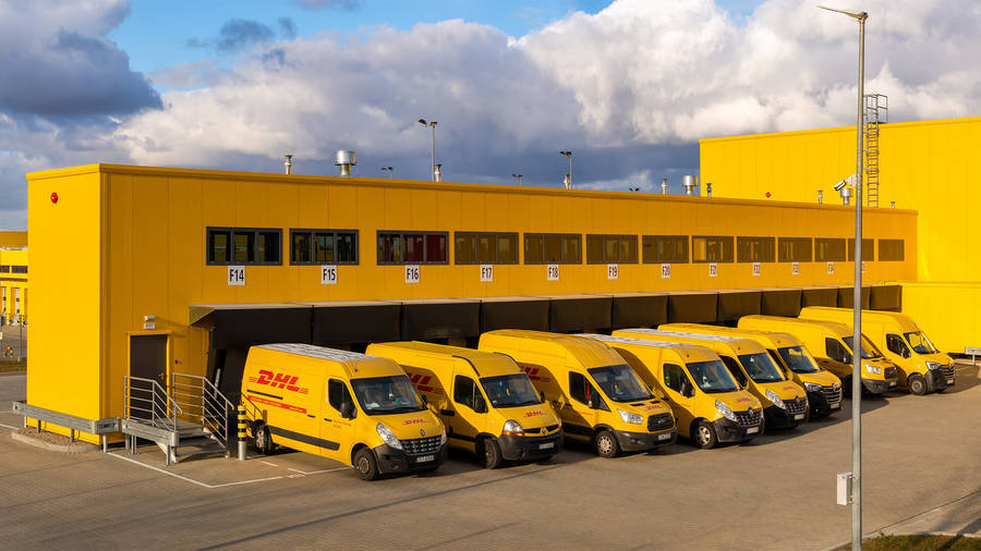 Caption: A Dhl Delivery Van In A Parking Area Wallpaper