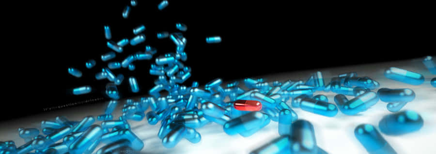 Caption: Blue And Red Medical Capsule In Descent Wallpaper