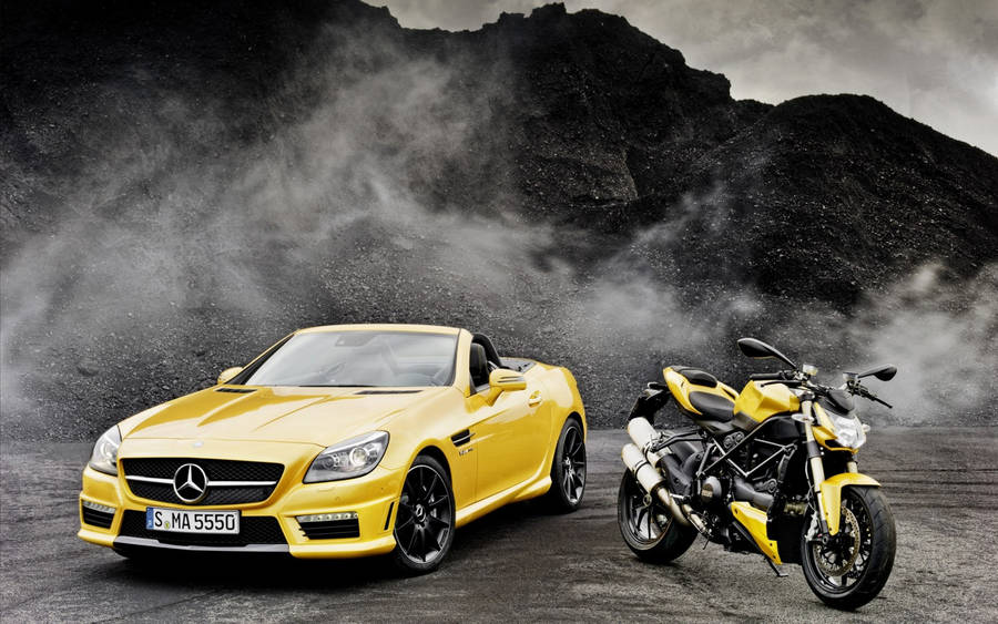 Caption: Elegance In Motion: Yellow Convertible Luxury Car Wallpaper