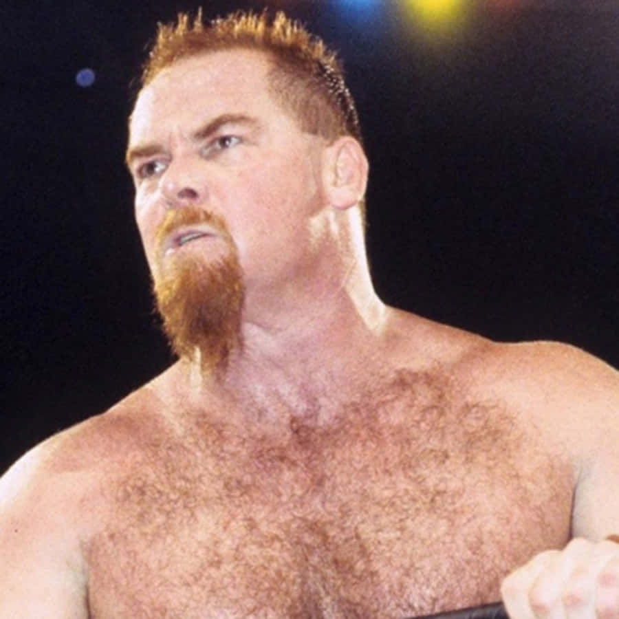 Caption: Iconic Portrait Of Wrestling Legend, Jim Neidhart Wallpaper
