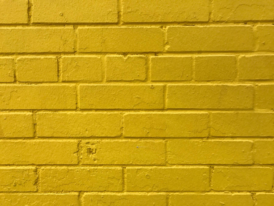 Caption: Radiant Golden Brick Wall Wallpaper
