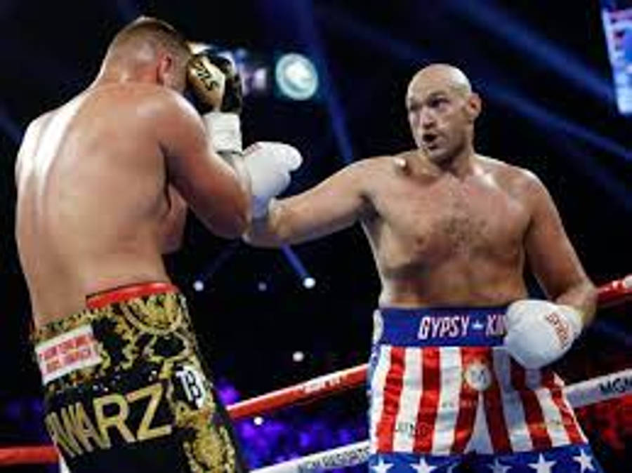 Caption: Tyson Fury Celebrates Victory In Boxing Ring Wallpaper