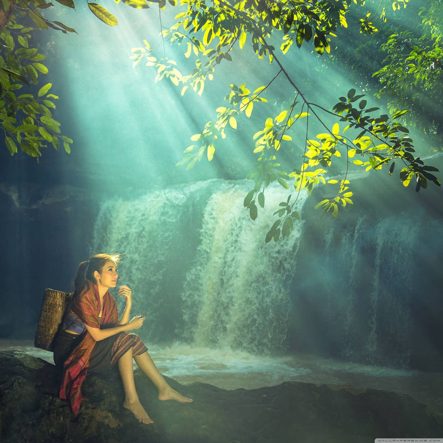 Capturing The Beautiful Moments Near A Peaceful Waterfall. Wallpaper