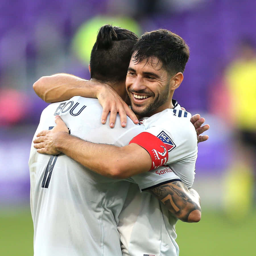 Carles Gil Hugging Gustavo Bou Wallpaper