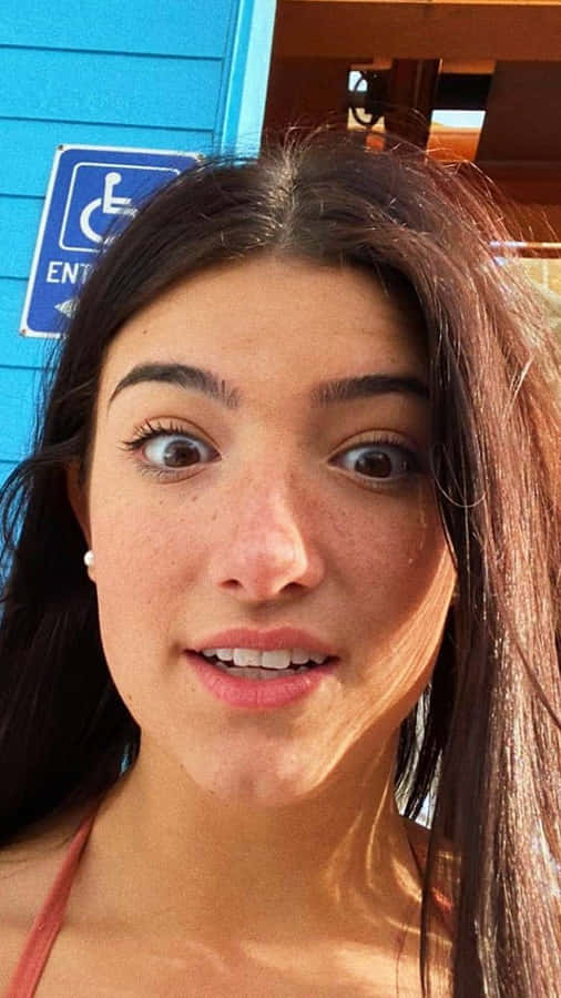 Charlie Damelio Spreads Positivity With Her Inspirational Videos And Dances. Wallpaper