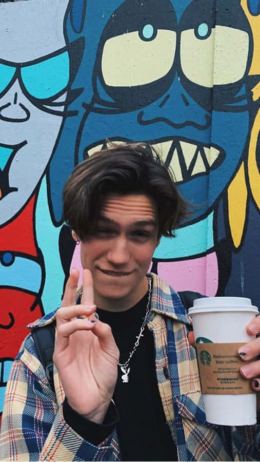 Chase Hudson Dressed In His Iconic Pink Hoodie Wallpaper