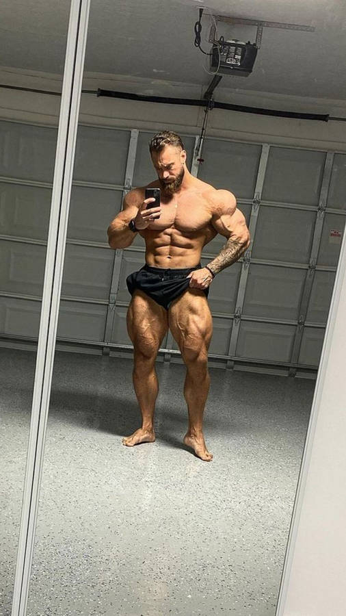 Chris Bumstead Taking A Mirror Selfie Wallpaper