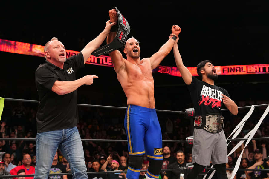 Claudio Castagnoli Hands Raised By Wheeler Yuta Wallpaper