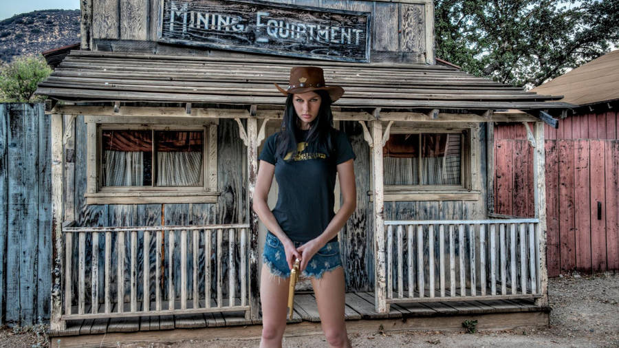Cowgirl Holding A Gun Wallpaper