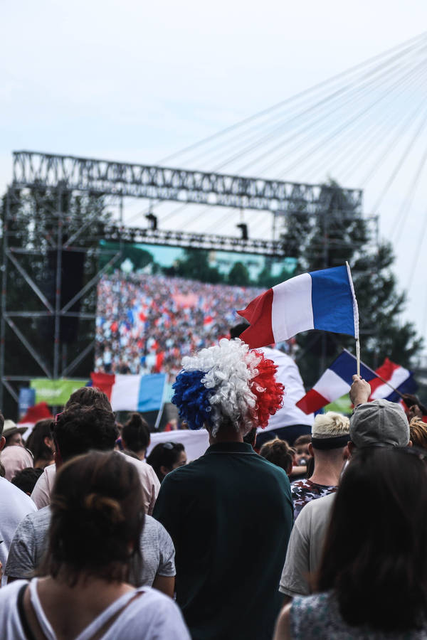 Crowd Of People Gathered Around Stage During Daytime Wallpaper