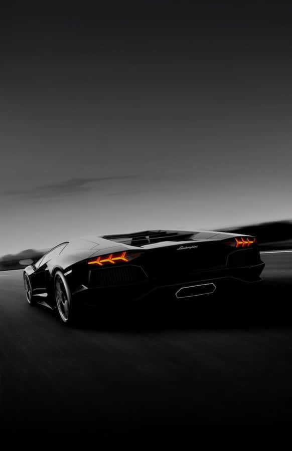 Cruise Down The Autobahn In Style In A Black Lamborghini. Wallpaper