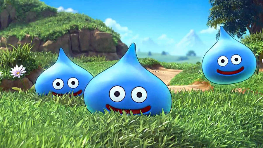 Cute Dragon Quest Slimes In Grassy Field Wallpaper