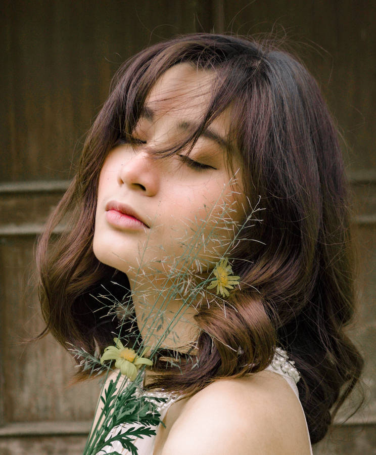 Cute Girl Closed Eyes Pose With Flower Wallpaper
