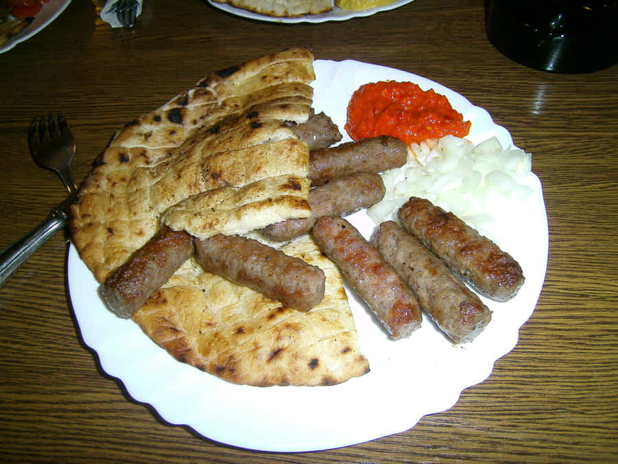 Delicious Grilled Ćevapi With Pita Bread Wallpaper