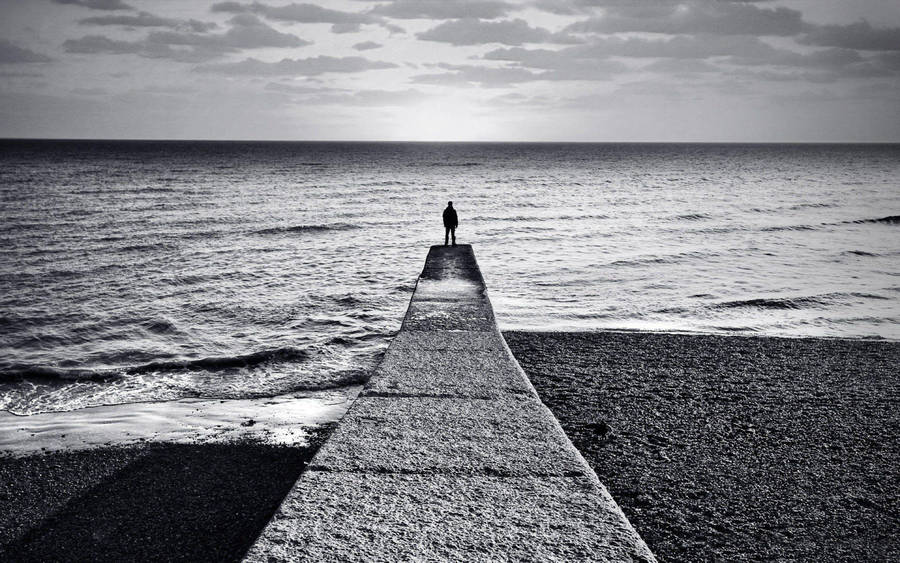 Depressed Man On Stone Dock Wallpaper