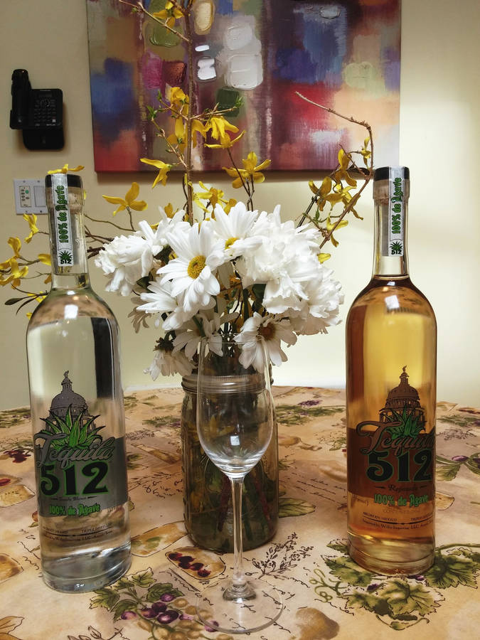 Elegant Bottle Of Tequila 512 With Distinctive Grey And Yellow Label Wallpaper