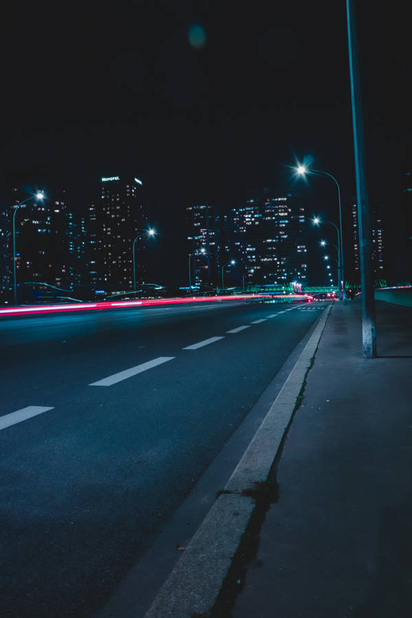 Empty Street With Lights During Nighttime Wallpaper