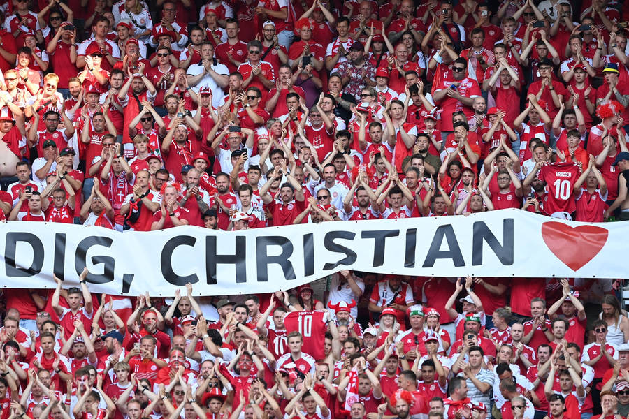 Energetic Denmark National Football Team Supporters Cheering At A Game Wallpaper