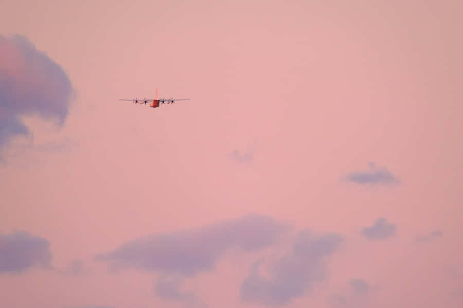 Enjoy A Beautiful Sunset Flight With Pink Plane Wallpaper
