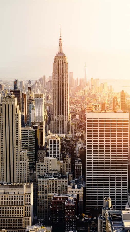 Enjoy A Panoramic View Of The City Skyline During A Spectacular Sunset. Wallpaper