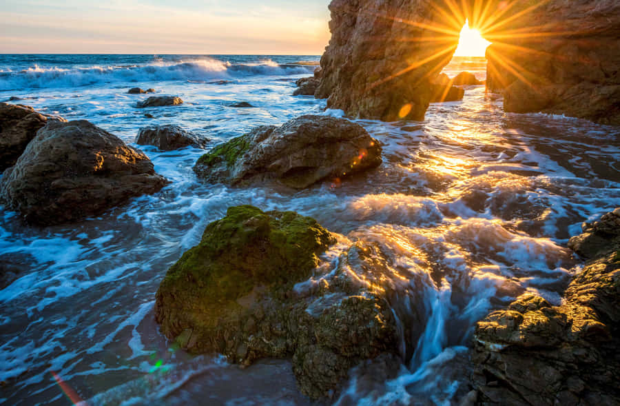 Enjoy The Beauty Of The Malibu Beach Sunrise Wallpaper