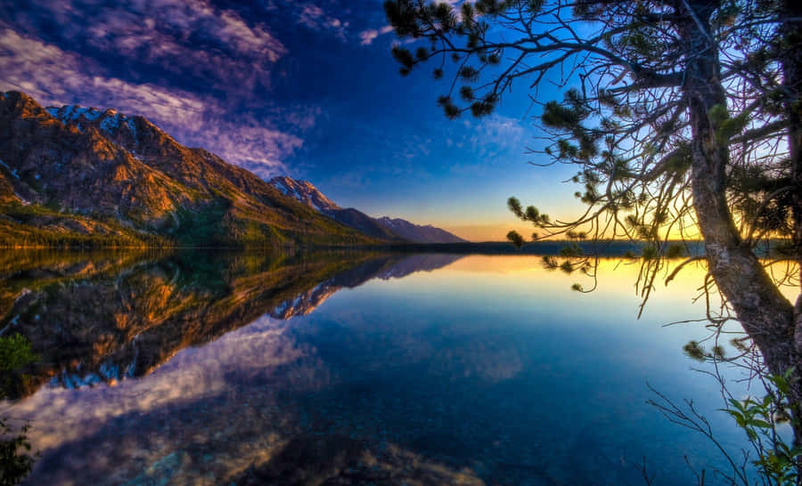Enjoy The Calming Views Of A Beautiful Lake. Wallpaper