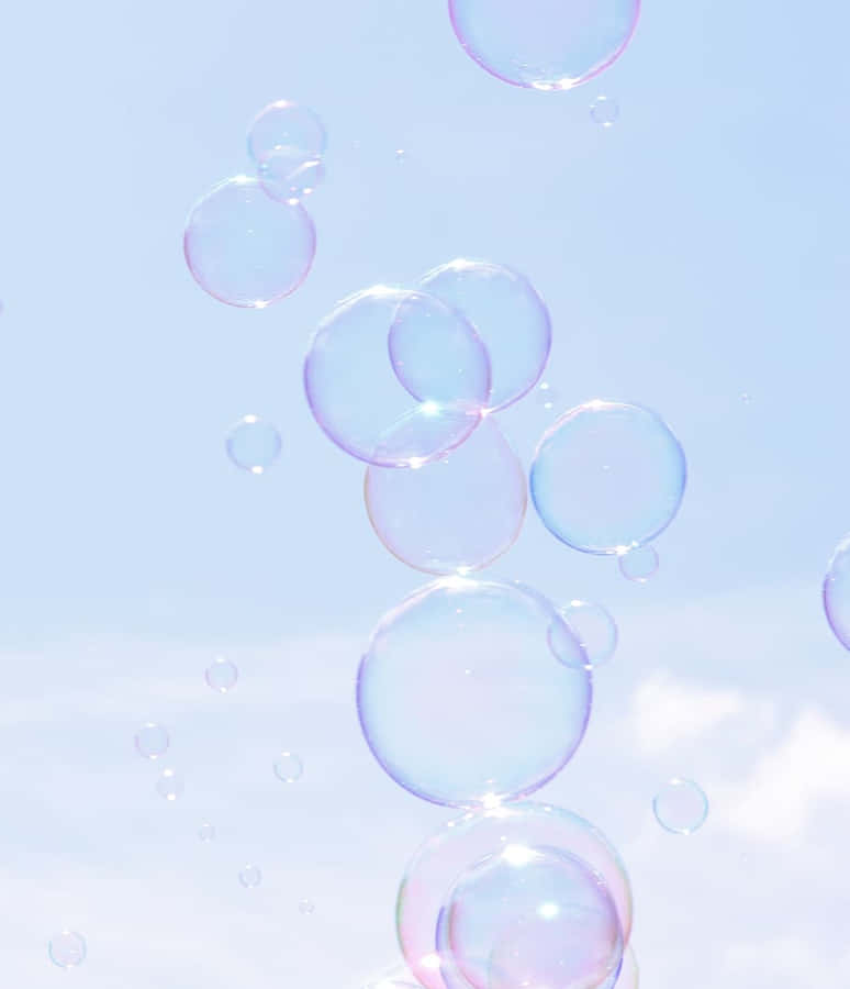 Ethereal_ Soap_ Bubbles_ Against_ Sky Wallpaper