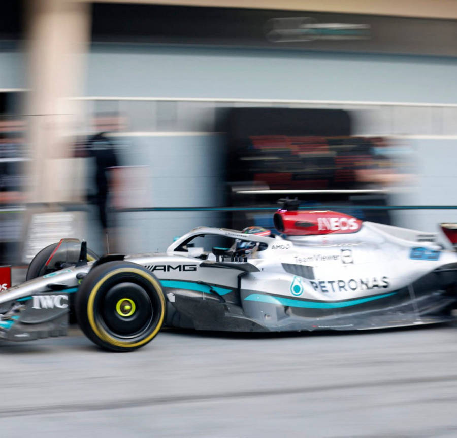 Experience The Excitement Of Mercedes F1 Racing On Your Iphone Wallpaper