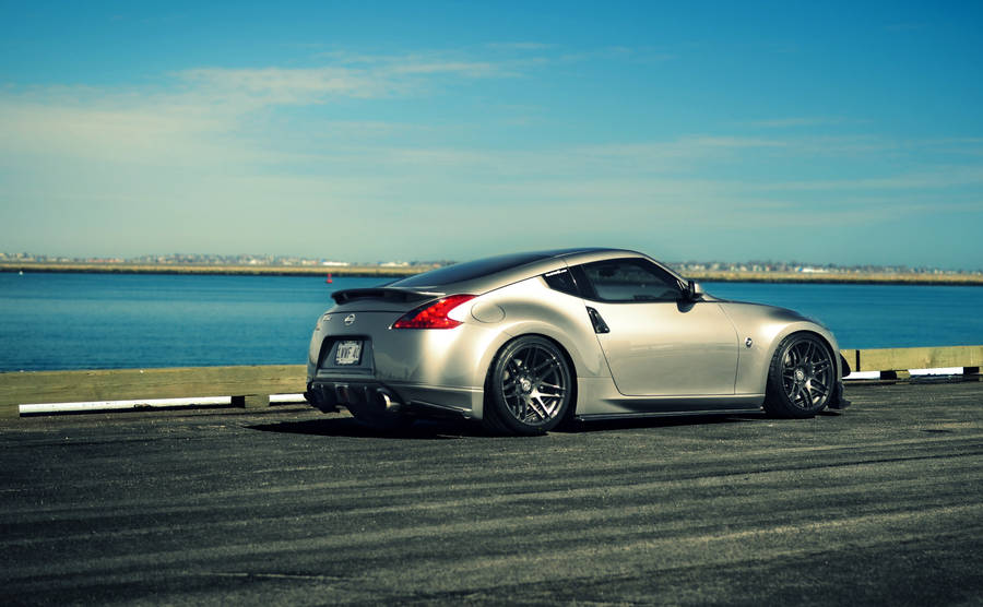 Experience The Ocean While Driving A Jdm Nissan 370z Wallpaper