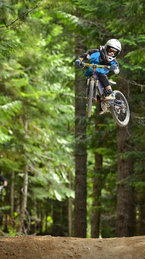 Feel The Thrill Of Adventure As You Cycle Through The Mountainous Terrain With Your Iphone. Wallpaper