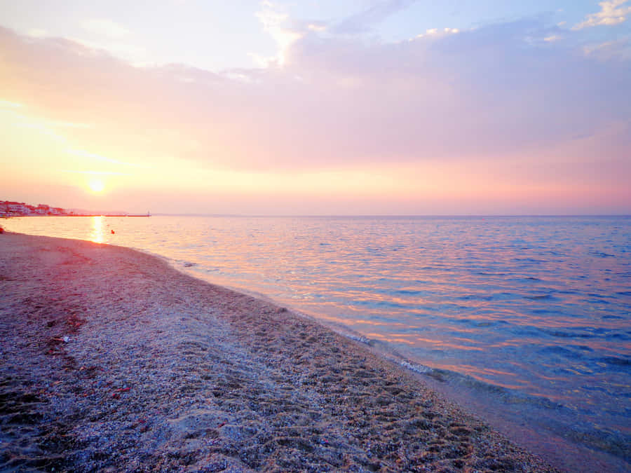 Feel The Warmth Of The Sun On The Peaceful, Sandy Shores Of Ocean Beach Wallpaper