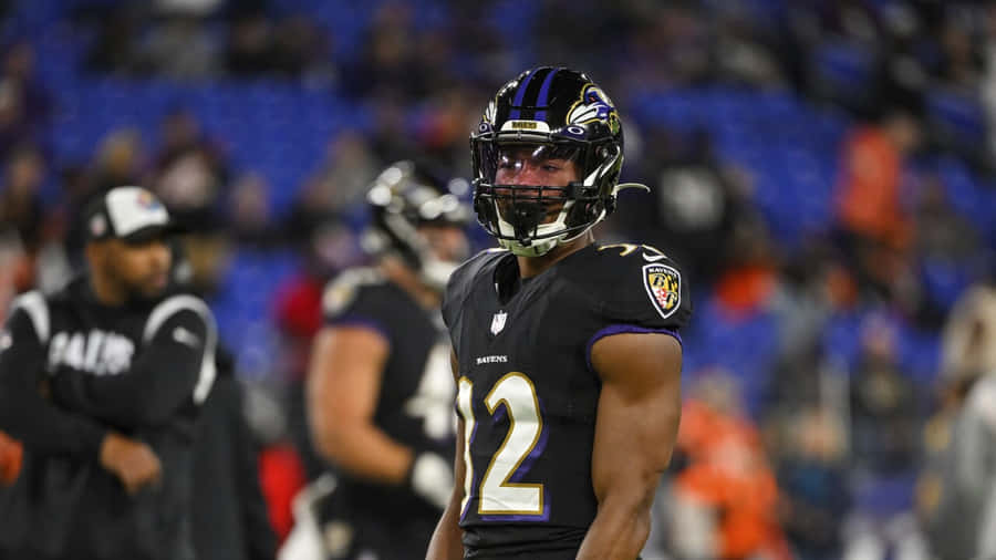 Focused Football Playeron Field Wallpaper