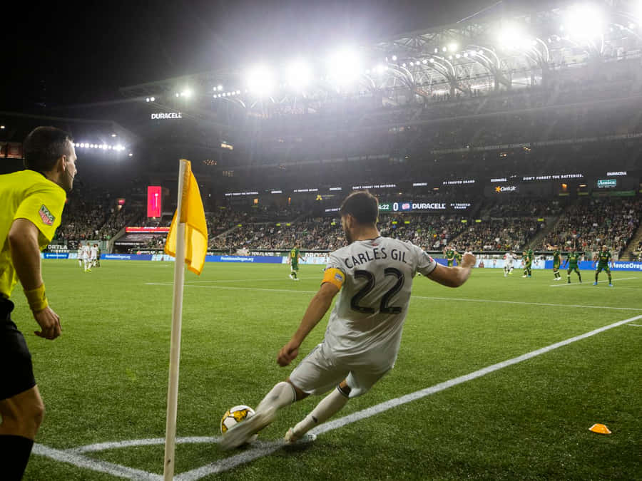 Football Player Carles Gil Kicking The Ball Wallpaper