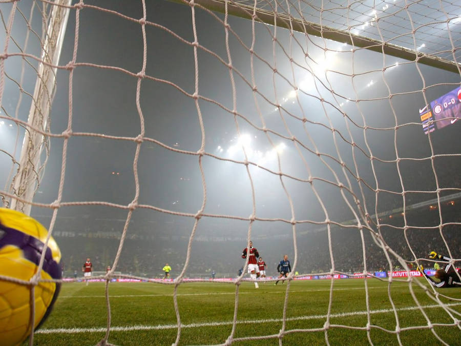 Football Players In The Heat Of The Game Wallpaper