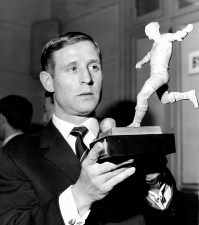French Footballer Raymond Kopa Holding A Football Trophy Wallpaper