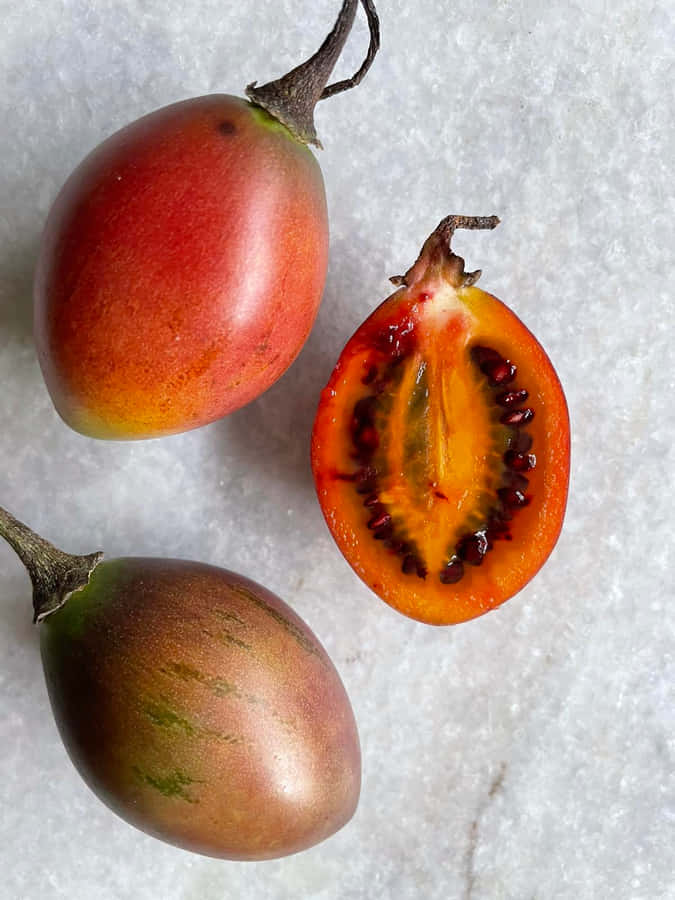 Fresh And Vibrant Tamarillo Trio Wallpaper