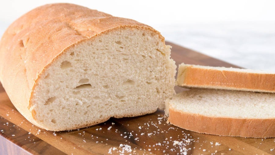 Freshly Baked Loaf With Slices Of Bread Wallpaper