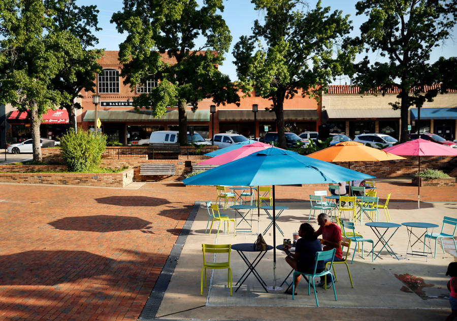 Garland Couple Enjoying A Stroll Through Downtown Wallpaper