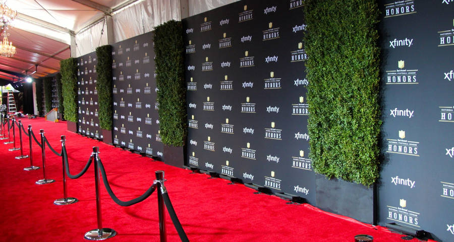 Glamorous Red Carpet Event Under Spotlights Wallpaper