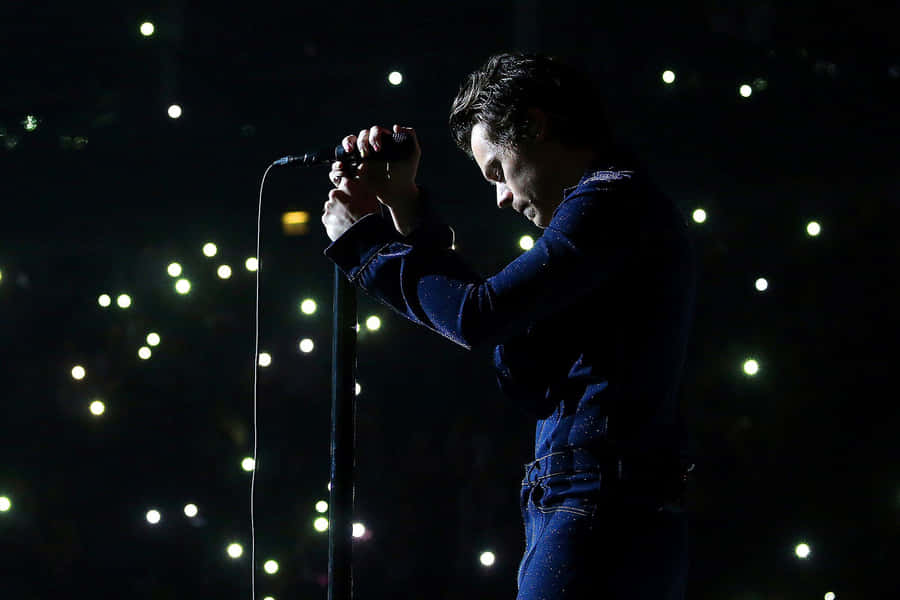 Harry Styles Playing On His Laptop Wallpaper