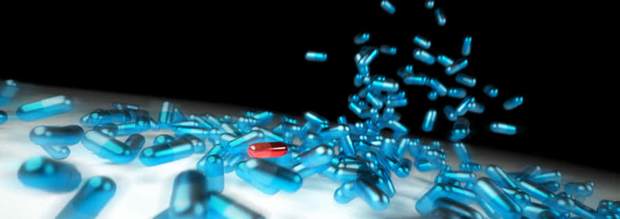 Hd Medical Red Capsule Among Blue Medicine Capsule Wallpaper