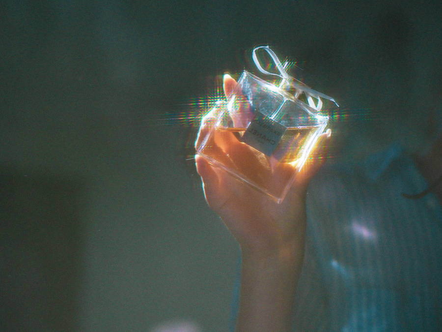 Holding Gabrielle Chanel Perfume Wallpaper