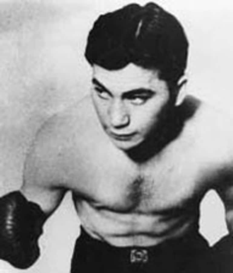 Hollywood Action Star Barney Ross Kicking Ass In The Expendables Wallpaper