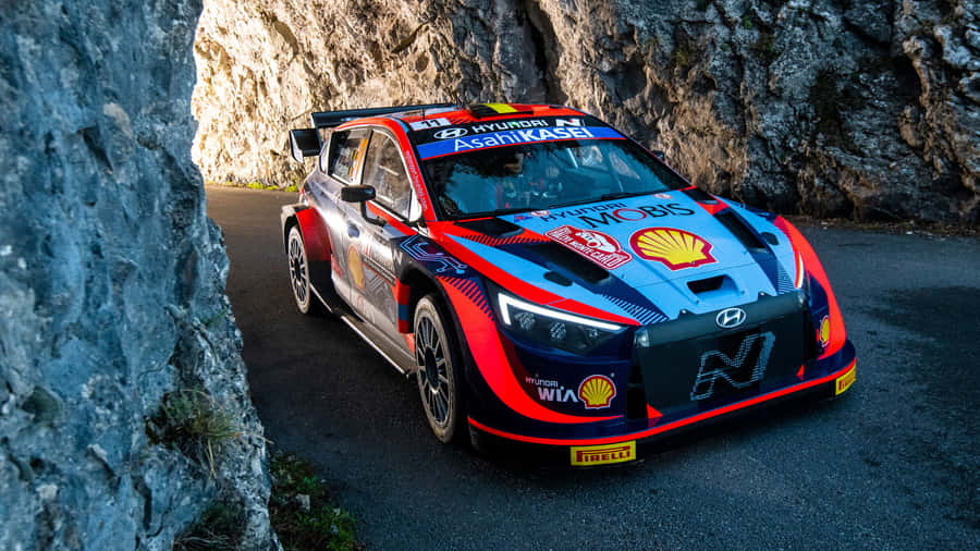 Hyundai Rally Car Speeding Through Mountain Pass.jpg Wallpaper